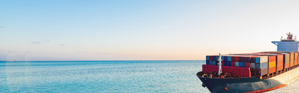 Container ship on the ocean with a clear sky