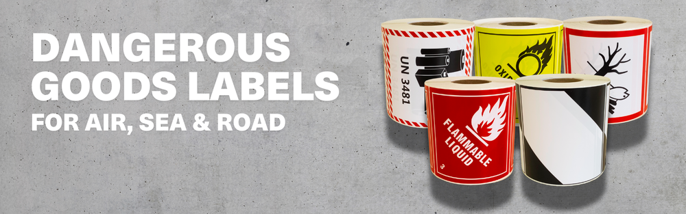 Collection of dangerous goods labels for air, sea, and road on a gray background.